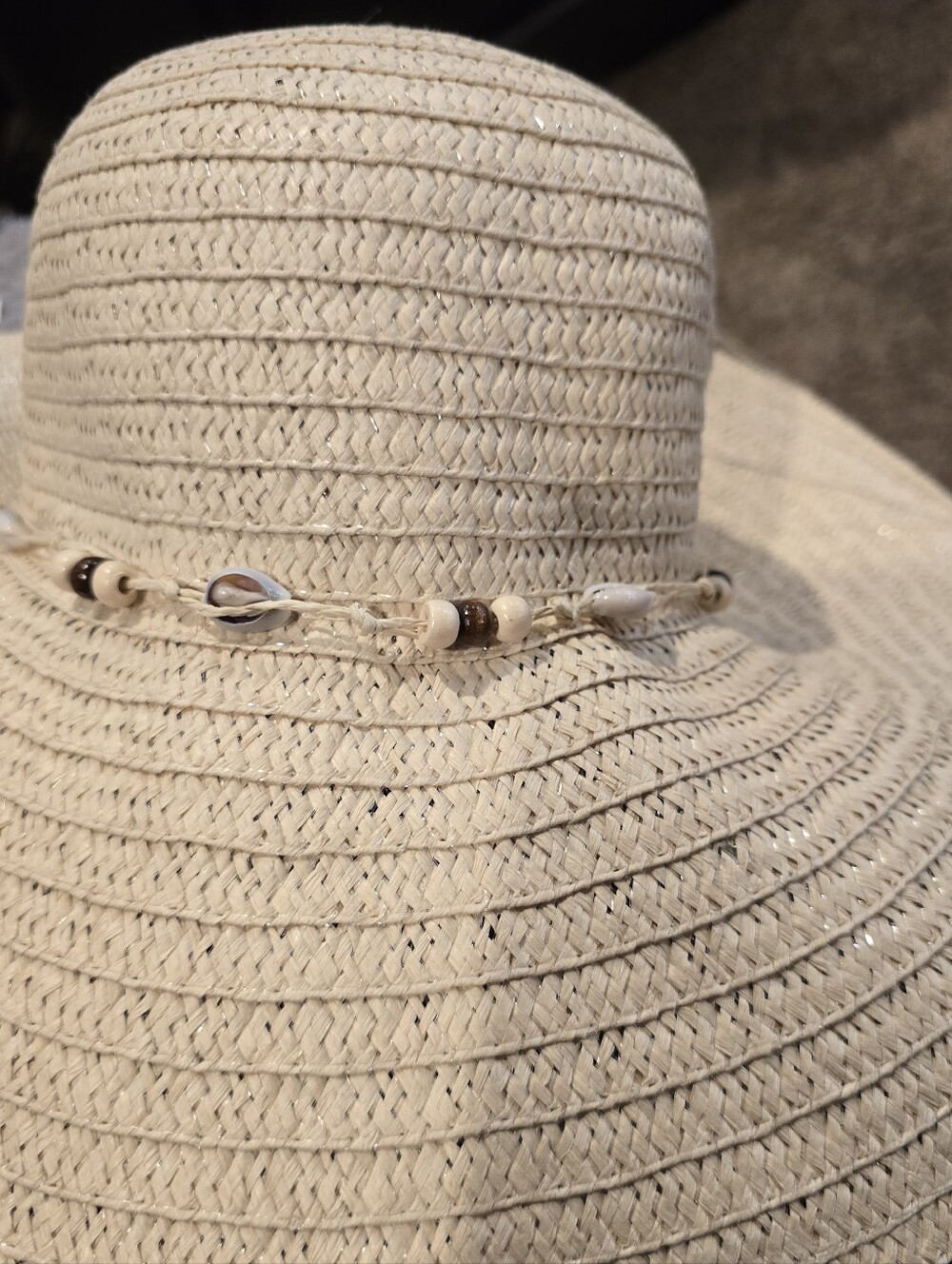 INC Beige wide-brim straw sun hat featuring a decorative trim with cowrie shells